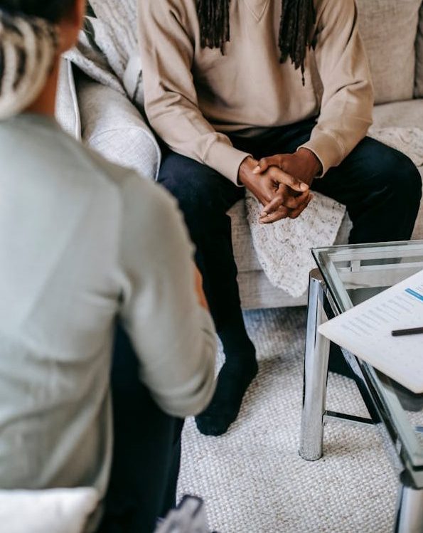 Black man explaining problem to female psychologist